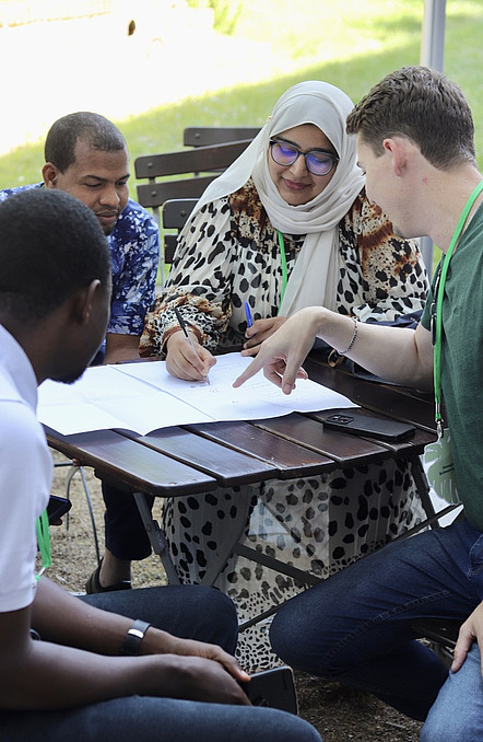 Four participants sitting at a table, working together