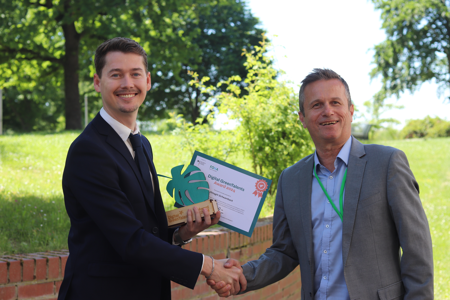 Portrait of Dimaghi Schwamback, shaking the hand of Rainer Müssner, Federal Ministry of Research, Technology and Space